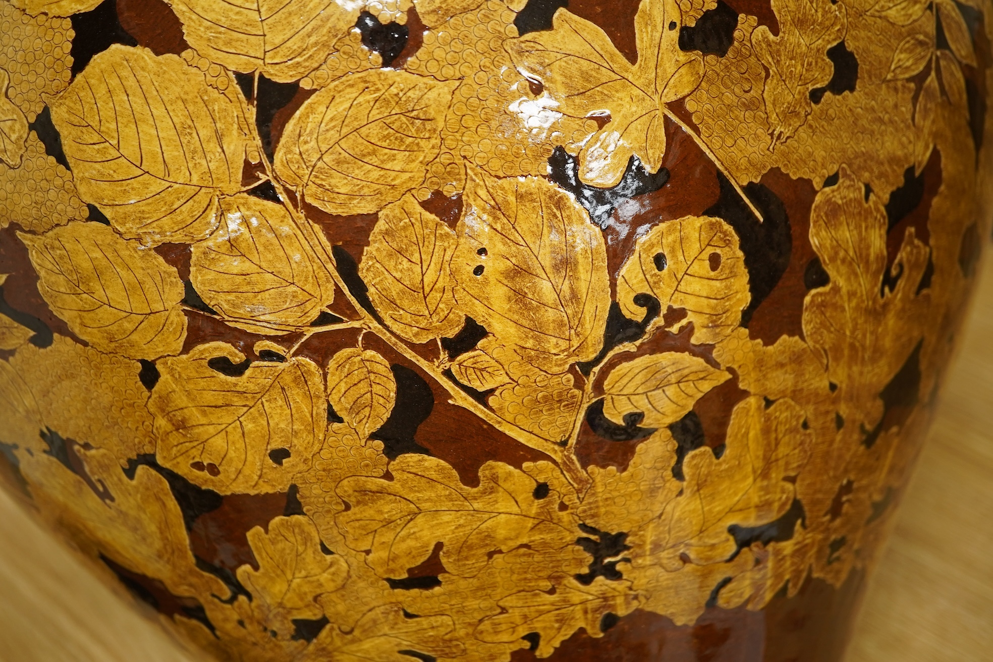 A large terracotta foliaiate decorated vase, 38cm high